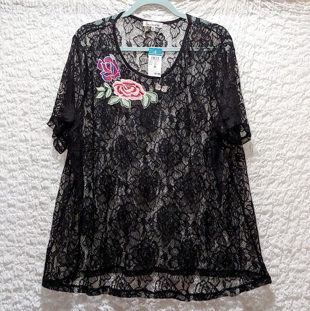 Lace blouse with floral accent.